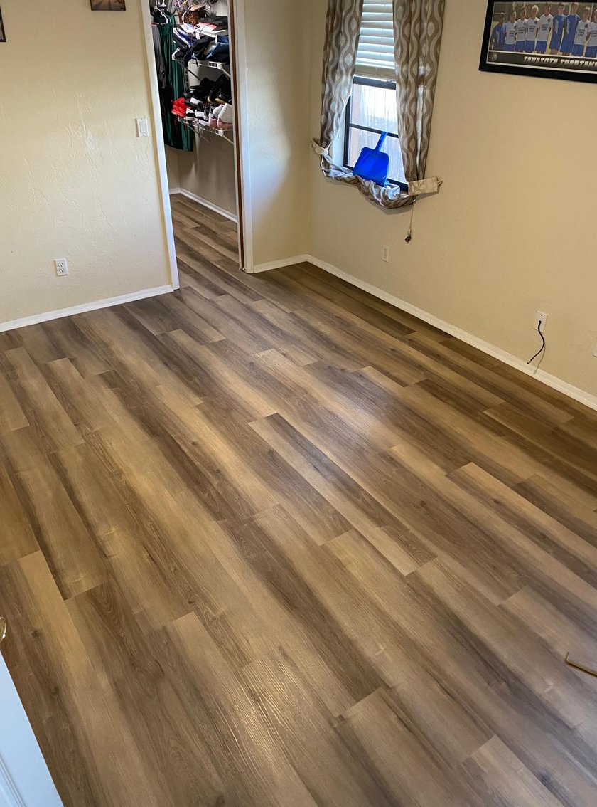 Bedroom with new warm-brown luxury vinyl plank flooring